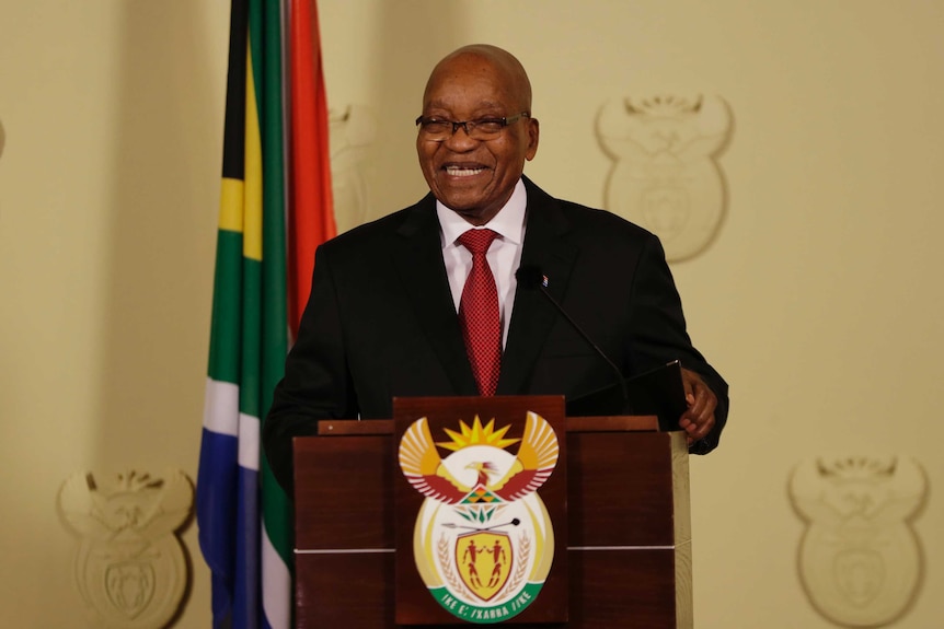 Jacob Zuma laughs as he addresses the media