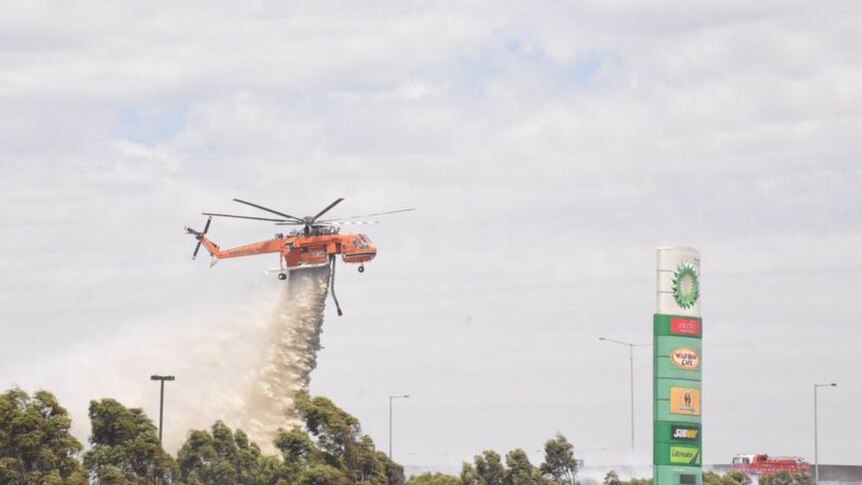 Waterbombers concentrate on dousing fire near Epping petrol station