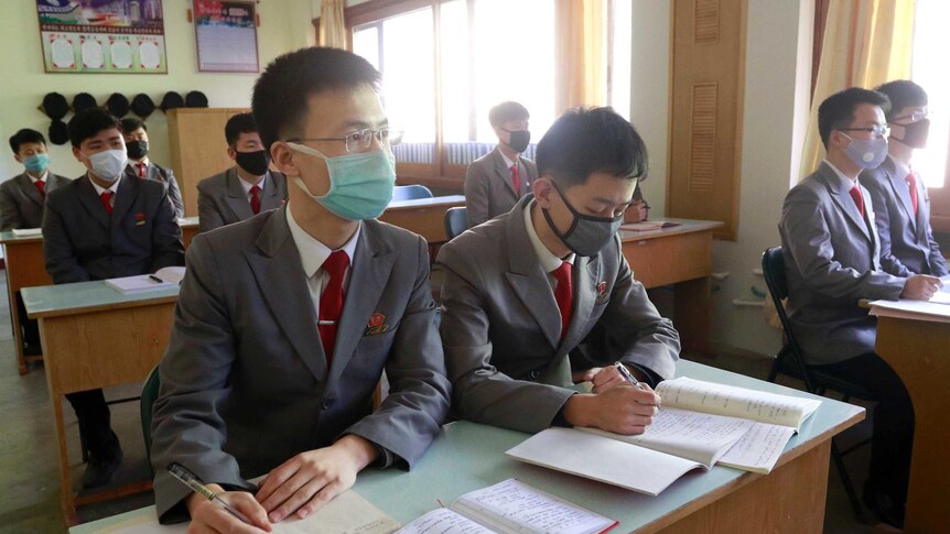Students with face masks attend the class as their university reopened following vacation at Kim Chaek University in Pyongyang.