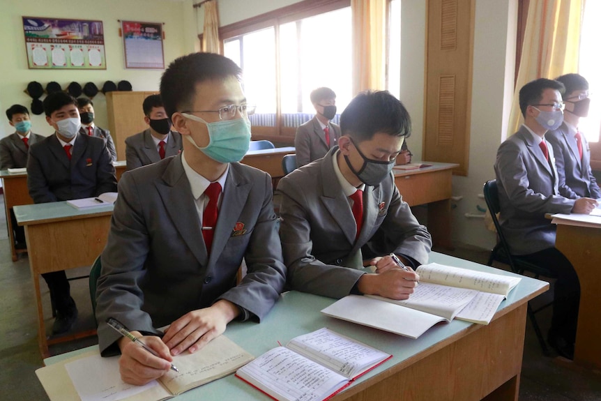 Students with face masks attend the class as their university reopened following vacation at Kim Chaek University in Pyongyang.