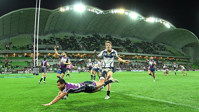 Triple treat: Justin O'Neill crosses for one of his three tries on the left wing for Melbourne.