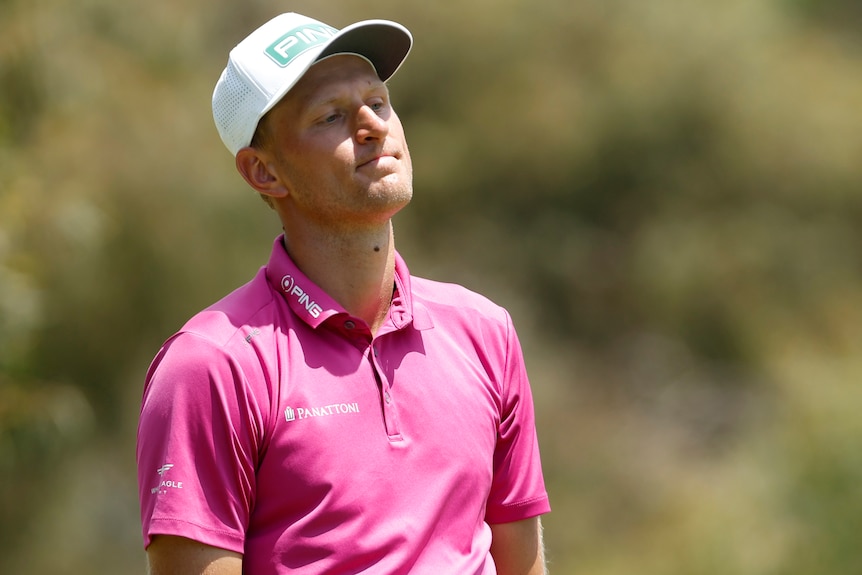 A Polish male golfer stands alone during the Australian Open final round.