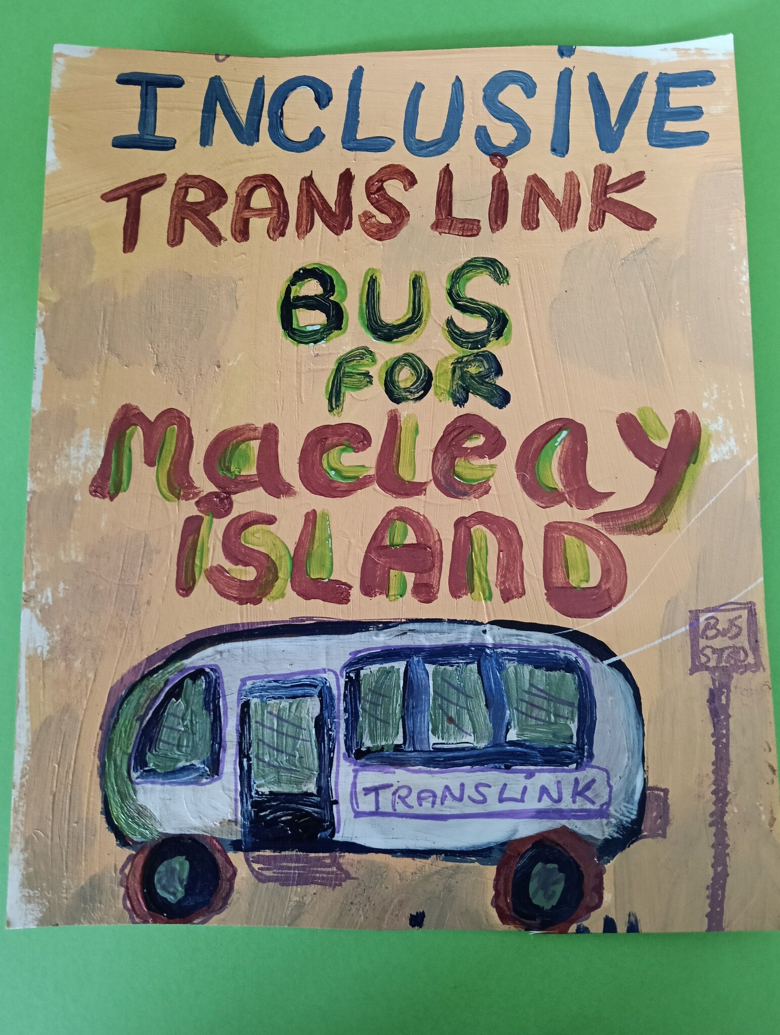 Hand-painted poster of a bus. The poster also says "Inclusive TransLink Bus for Macleay Island". 