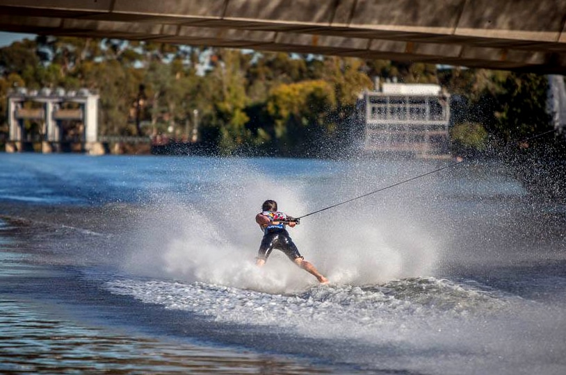 A man skis backwards on the River Torrens.