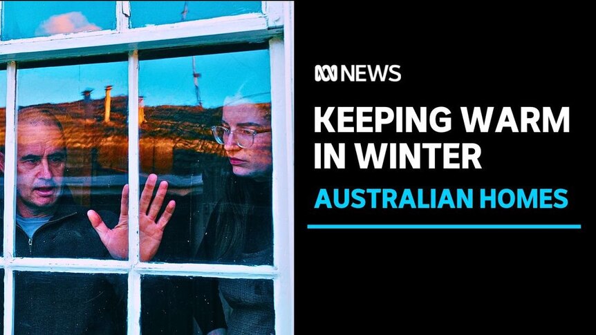 Keeping warm in winter. Australian homes. Man standing at window checking for drafts. Woman watches. 