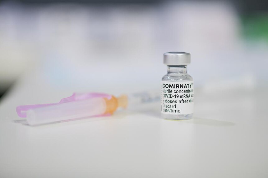 A COVID vaccine vial and syringe.