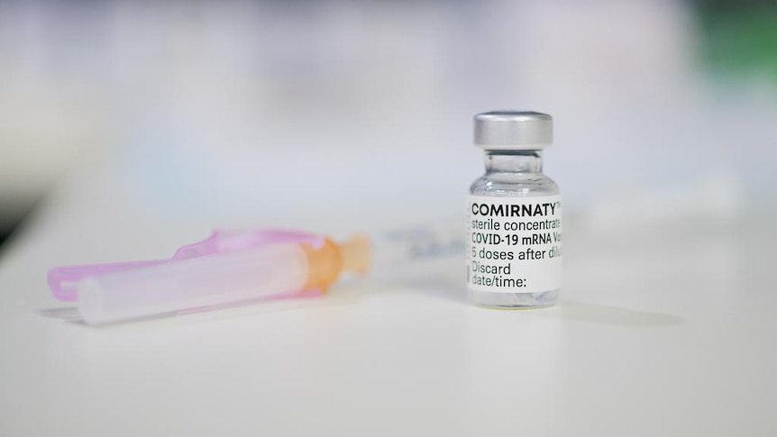 A COVID vaccine vial and syringe.