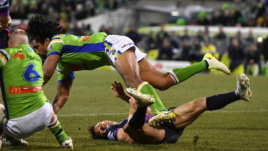 Billy Slater knocked onto the turf by Sia Soliola