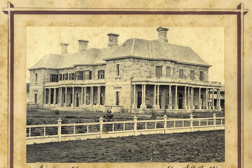 A framed black and white photo of the grand, two story sandstone Jimbour House near Dalby, Queensland, ca. 1877.