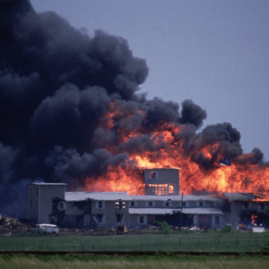 Branch Davidians' Mount Carmel compound burning with smoke and fire
