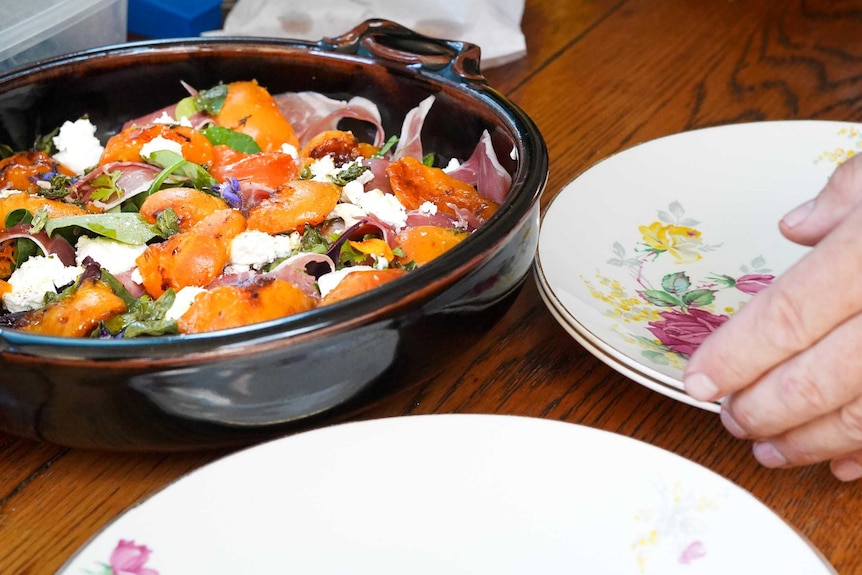 Brenton Lynch-Rhodes prepares a colourful salad with mixed leaves, tarragon, grilled peaches, prosciutto and goat's cheese.