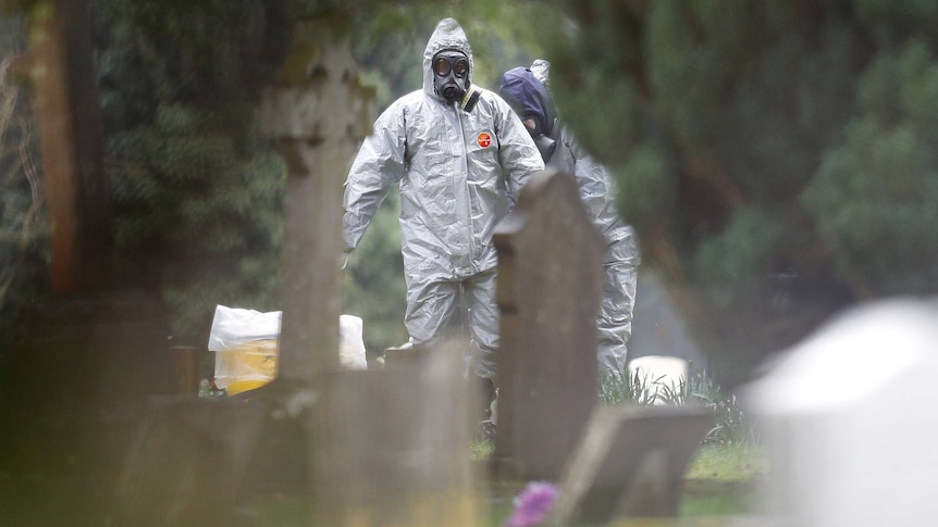 Forensic workers in protective suits investigate at the graves of Sergei Skripal's wife Liudmila and son Alexander.