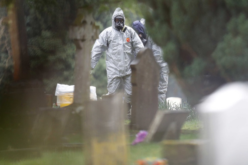 Forensic workers in protective suits investigate at the graves of Sergei Skripal's wife Liudmila and son Alexander.