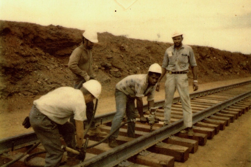 Archival photo of men working on a railway track.