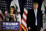 Sarah Palin and Donald Trump on stage at rally.