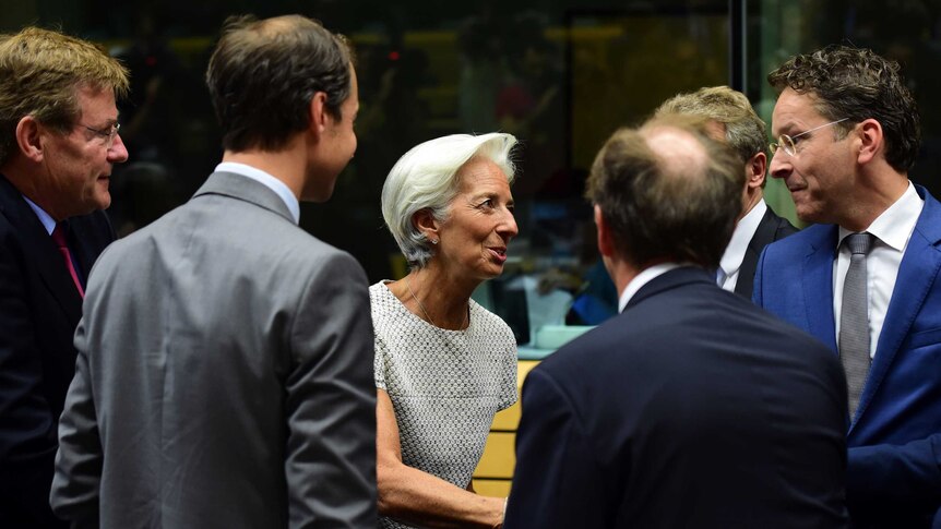 Christine Lagarde (centre) greets president of the Eurogroup Jeroen Dijsselbloem (right).
