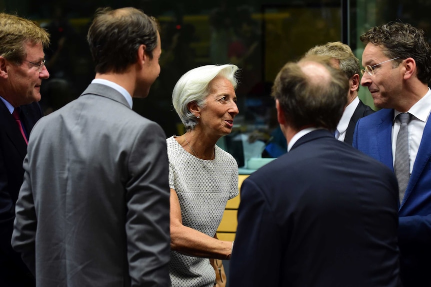 Christine Lagarde (centre) greets president of the Eurogroup Jeroen Dijsselbloem (right).