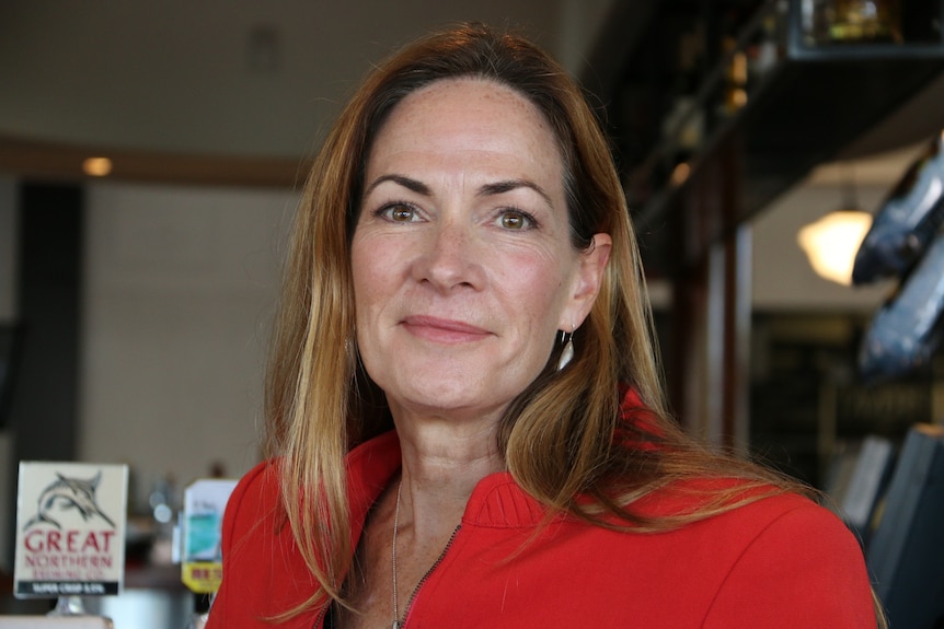 Eumundi CEO Suzanne Jacobi-Lee wears a red jacket in a close-up shot.