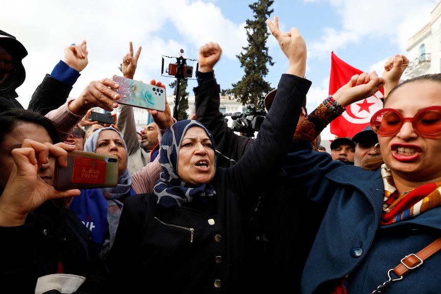 Women hold their fists in the air during a demonstration.