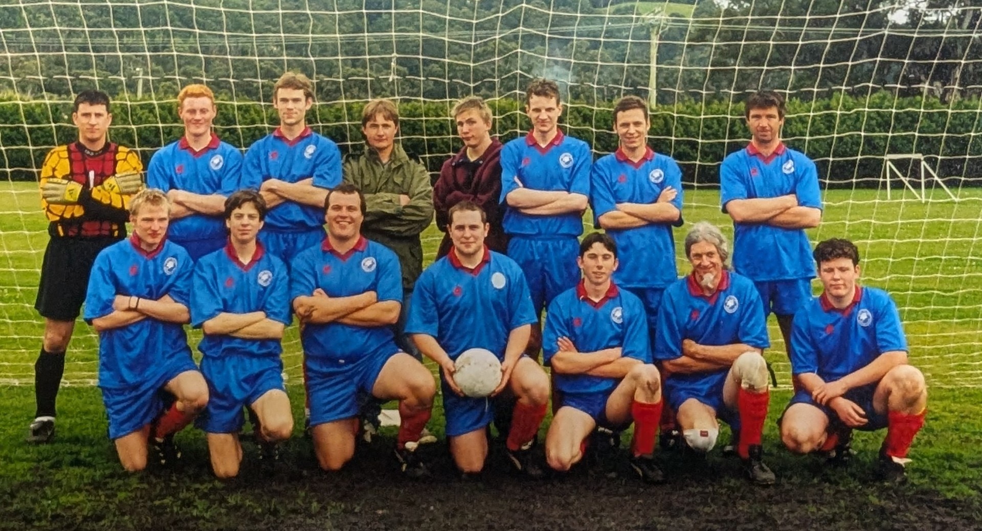 A film photo of a men's soccer team, wearing a blue uniform
