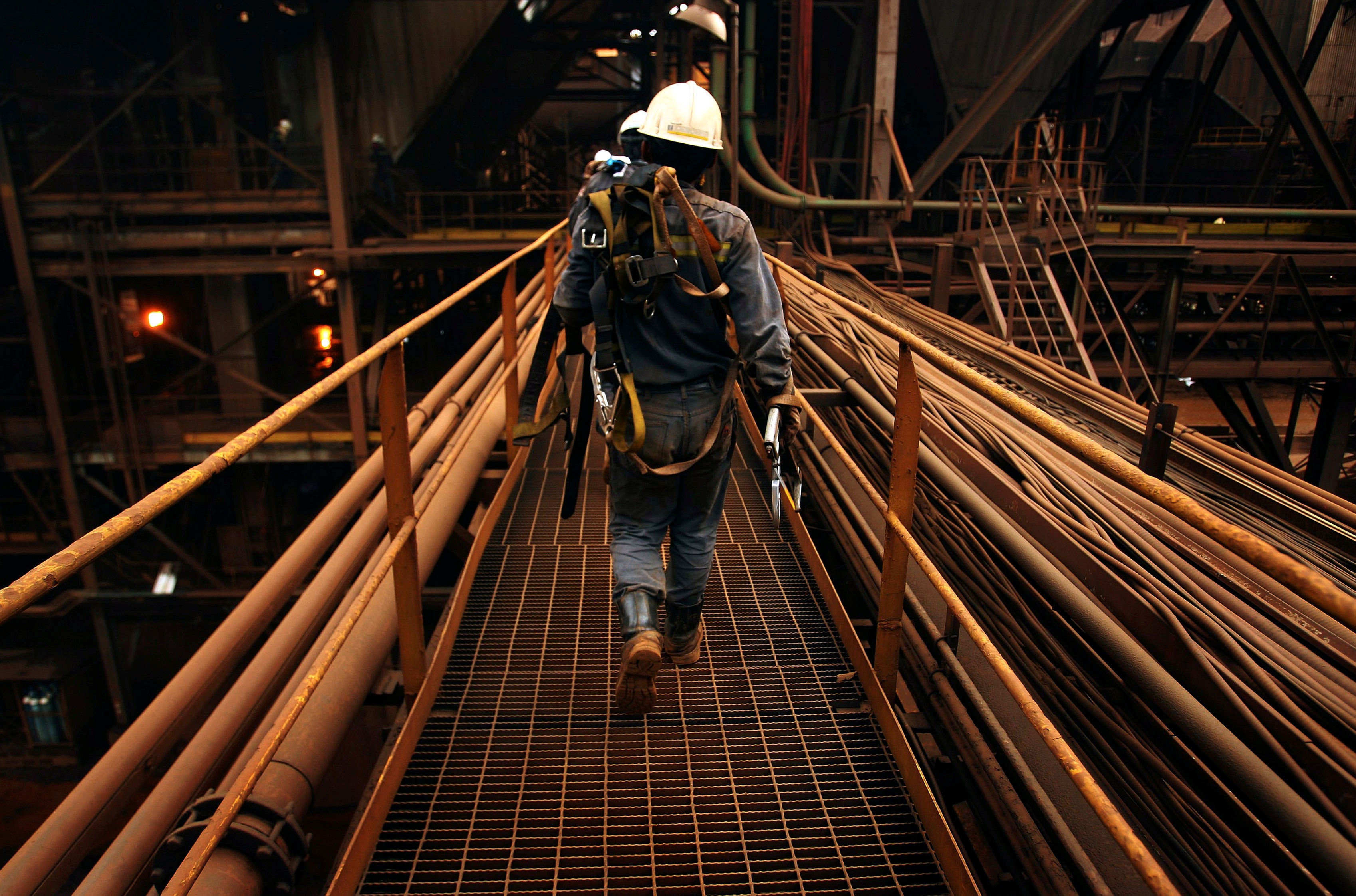 Worker wearing PPE captured from behind.