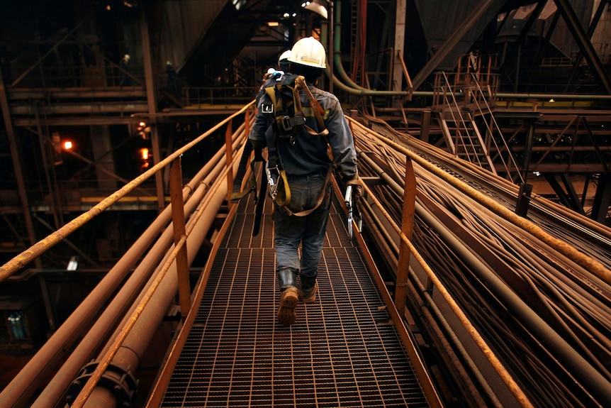 Worker wearing PPE captured from behind.