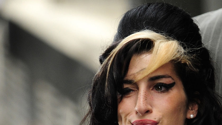 Headshot of Amy Winehouse with her beehive hair and lots 'o makeup.