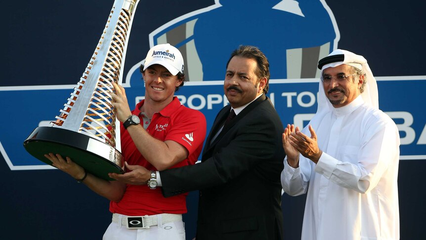 Winning conclusion ... Rory McIlroy (L) celebrates with the Race to Dubai trophy.