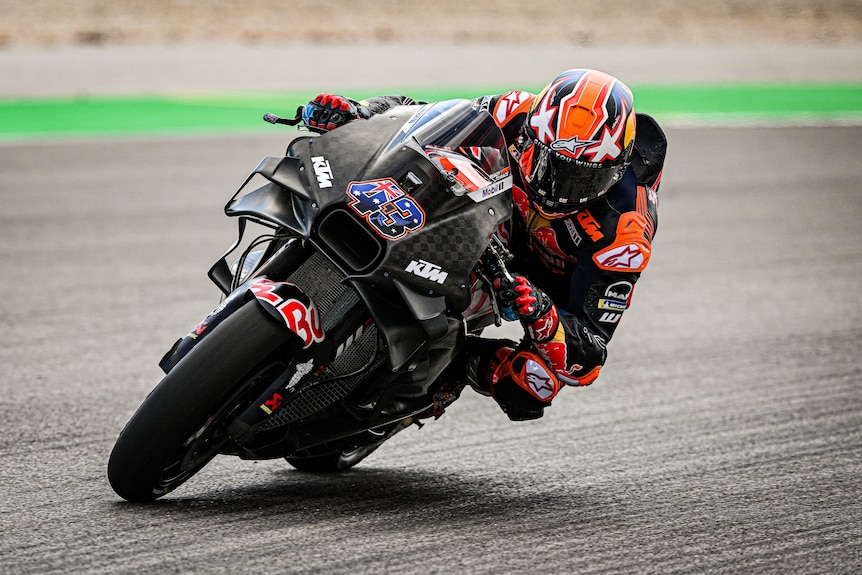 Jack Miller rides a black motorbike