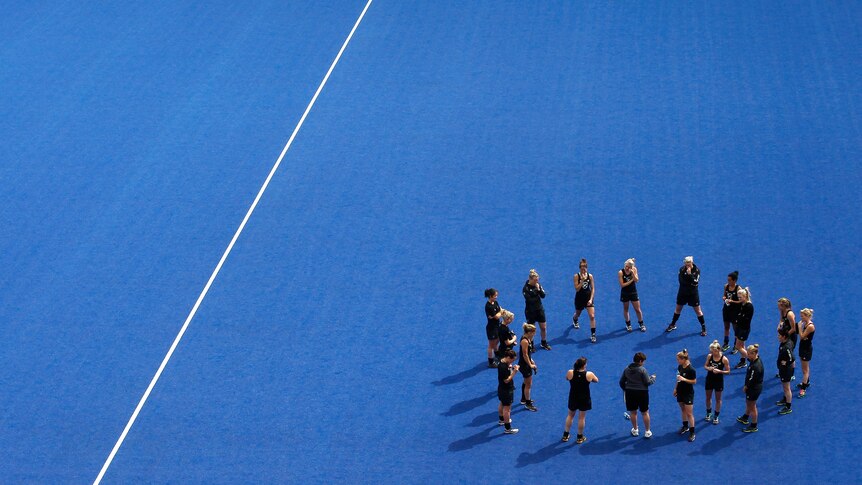 the New Zealand team stretches after a training session at the Olympic Hockey venue.