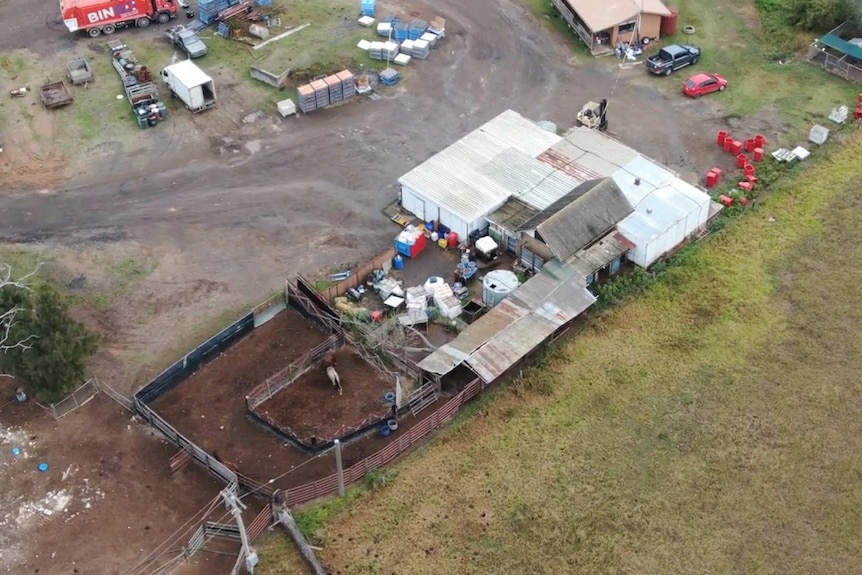 Aerial of the yards at Luddenham Pet Meat, with stock pens, trucks, farm vehicles and crates