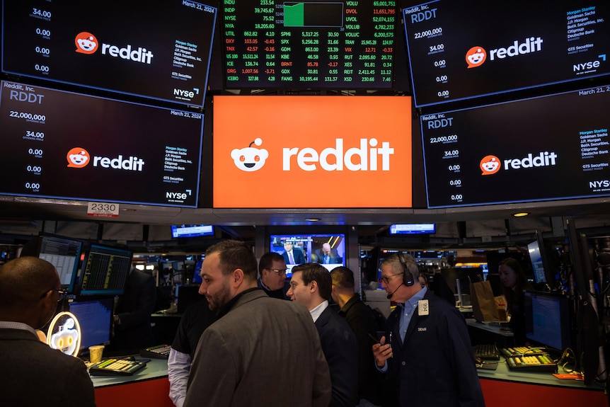 Reddit is seen on screens on the New York Stock Exchange trading floor.