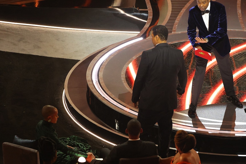 Denzel Washington and Jada Pinkett Smith speak to Will Smith after he hit Chris Rock onstag at the Oscars.