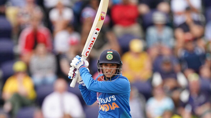 India batter Smriti Mandhana watches her shot race away during a Twenty20 against Australia.