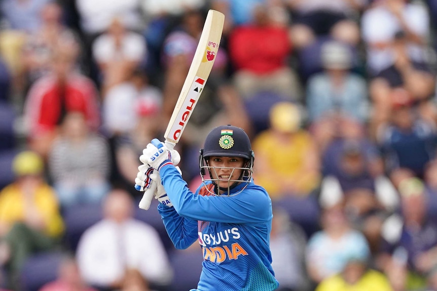 India batter Smriti Mandhana watches her shot race away during a Twenty20 against Australia.