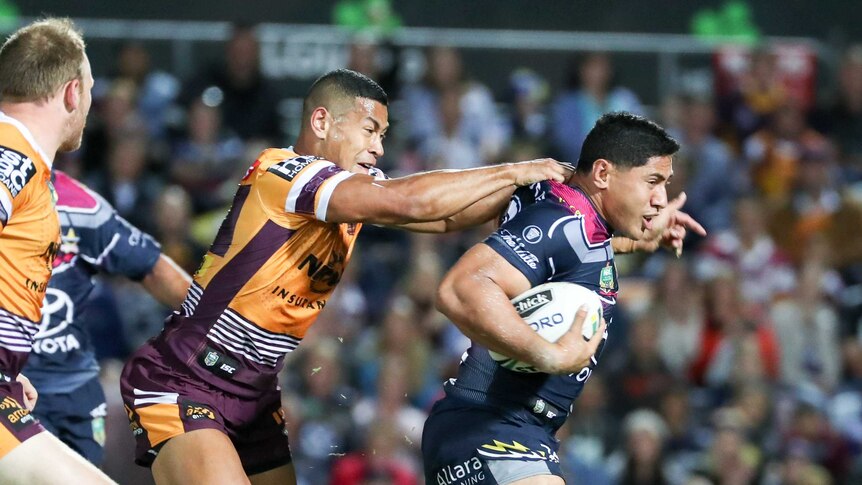 Taumalolo tries to burst clear of Broncos defence