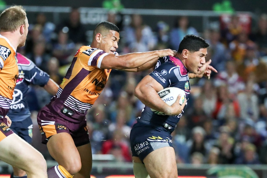 Taumalolo tries to burst clear of Broncos defence