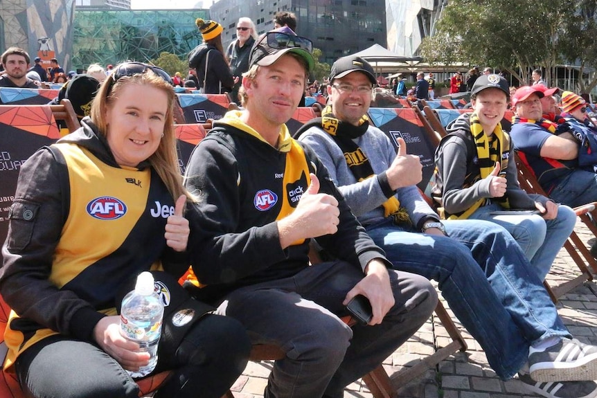 Tigers fans give a thumbs up sign in Federation Square.