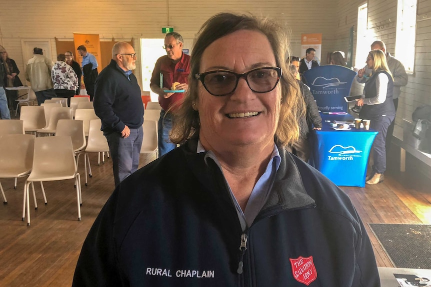 Salvation army rural chaplain Dianne Lawson stands in front of people gathered at a country hall in NSW
