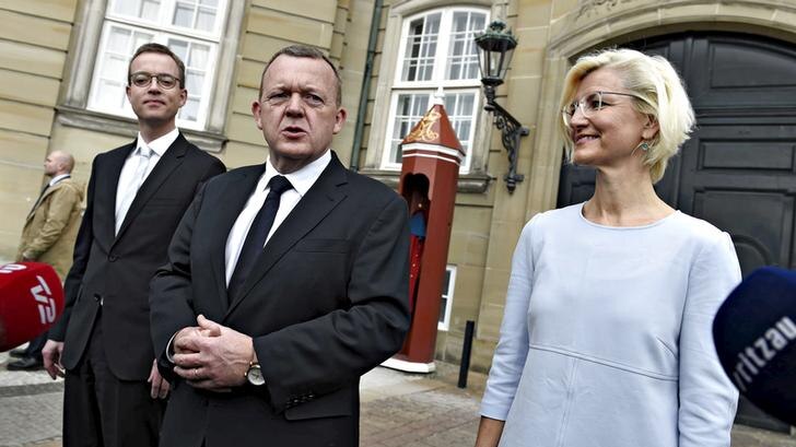 Danish Prime Minister Lars Lokke Rasmussen stands with Esben Lunde Larsen, left, and Ulla Tornaes, right