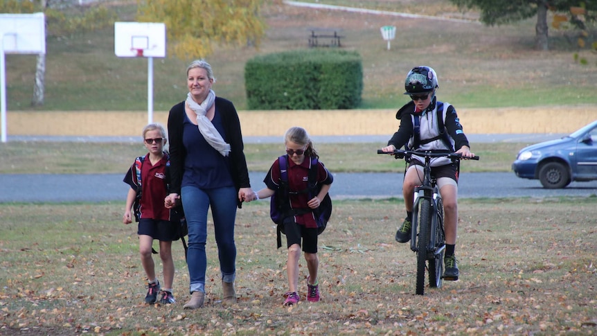 The Gillies family walking in a park.