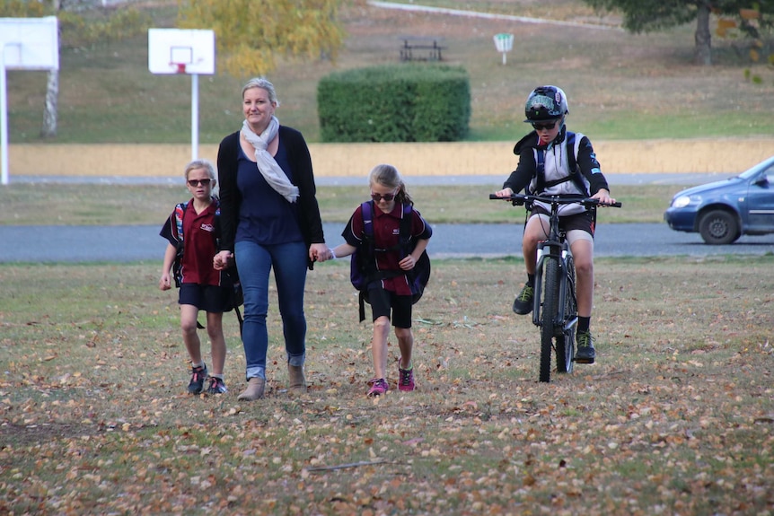 The Gillies family walking in a park.