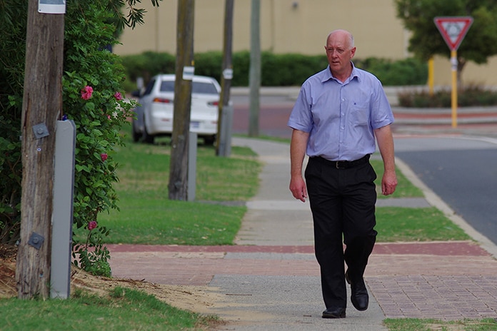 Paul Miles walks along a suburban street.