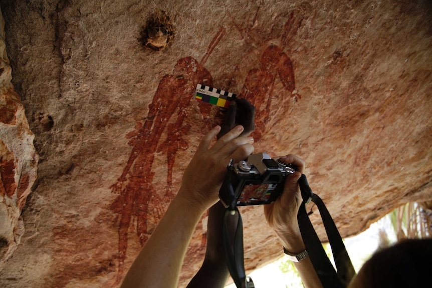 Scientists photographing rock art