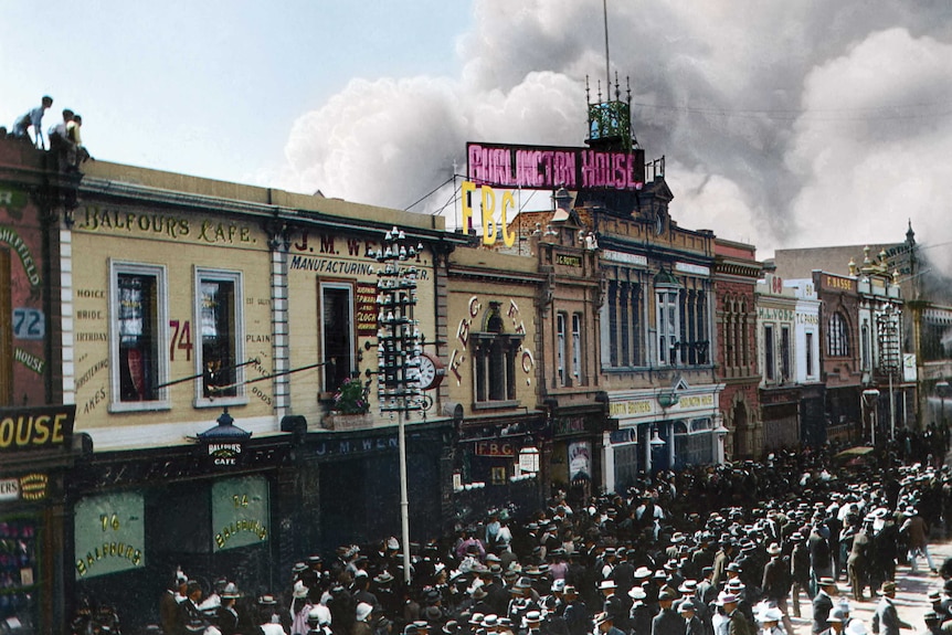 A colourised historical photograph of smoke rising from the John Martin's department store in Adelaide, 1901.