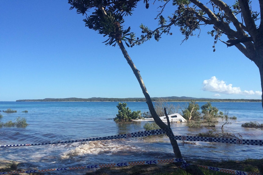 A caravan submerged in the ocean by a near-shore landslide at Inskip Point near Rainbow Beach in south-east Queensland