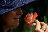 A woman smells a flower