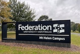 Signage for Federation University, Mt Helen Campus standing in green grass
