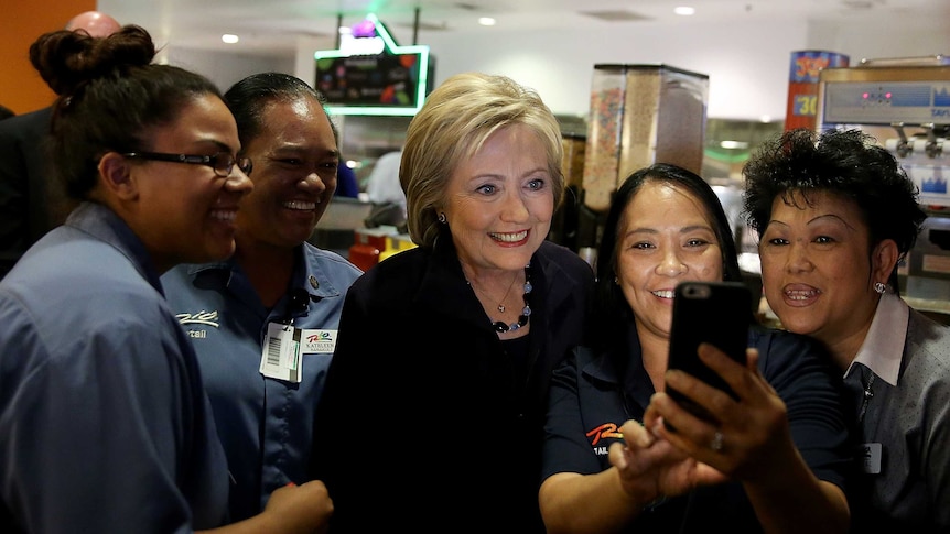 Democratic presidential candidate Hillary Clinton takes a selfie with four female hotel workers in Las Vegas, Nevada