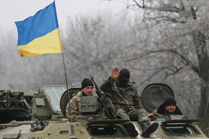 Ukrainian soldier in a military vehicle